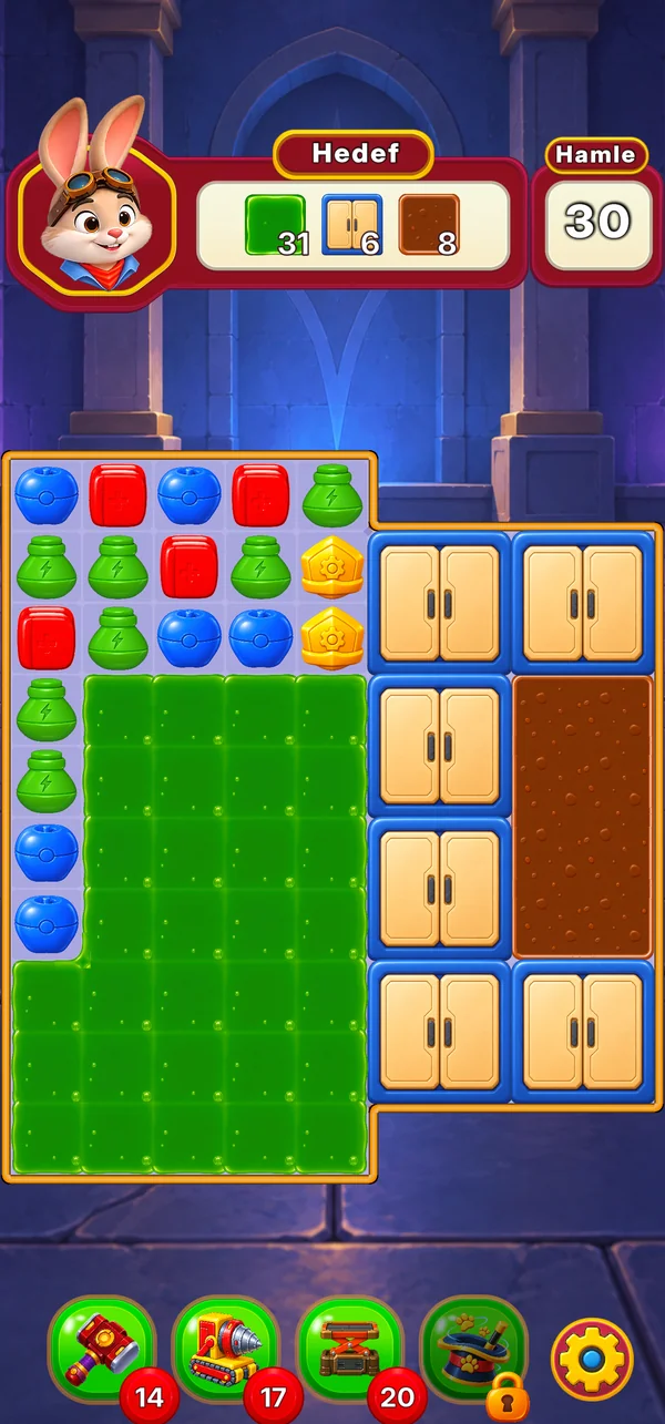 A grass field beside blue cabinets and a patch of mud in a blue stone hall